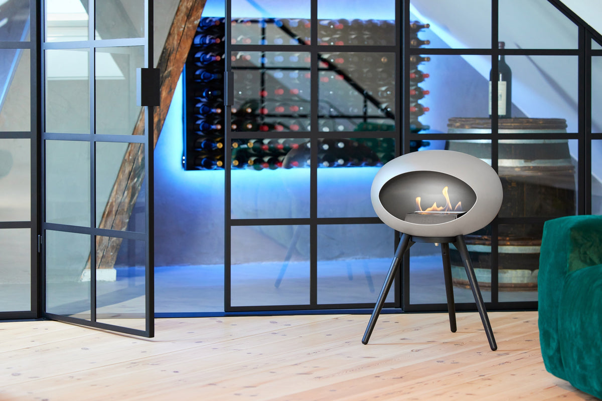 Le Feu Dome Ground Low freestanding bioethanol fireplace with real flames in a living room