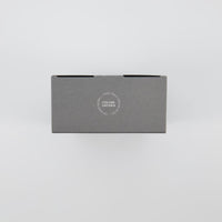 Top of the Nicolas Vahé Salt and Pepper gift box showing the Ceramic Grinder seal for finely ground spices and more aroma