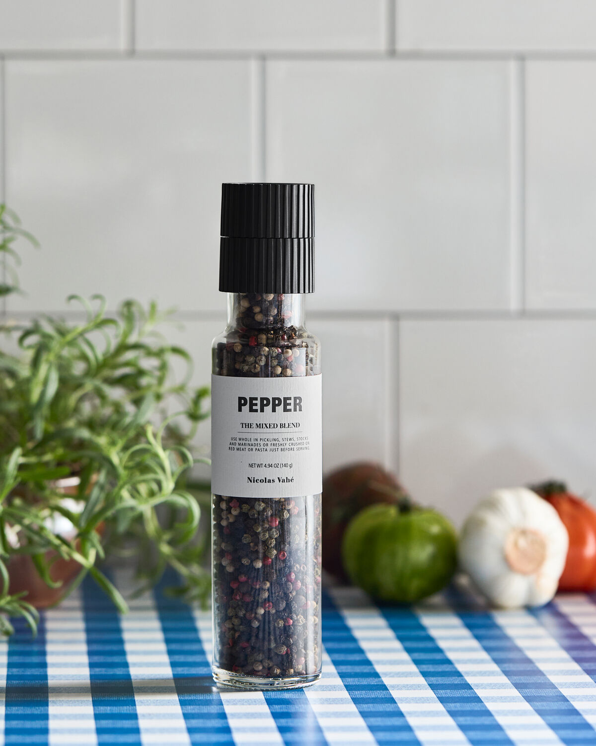 Nicolas Vahé Mixed Blend pepper mill on a kitchen worktop with rosemary and fresh vegetables