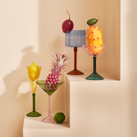 colourful cocktail glasses styled with fruit including pink coupe glass by Urban Nature Culture