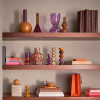 colourful mango wood candle holder Signe by Urban Nature Culture styled on warm wooden shelves