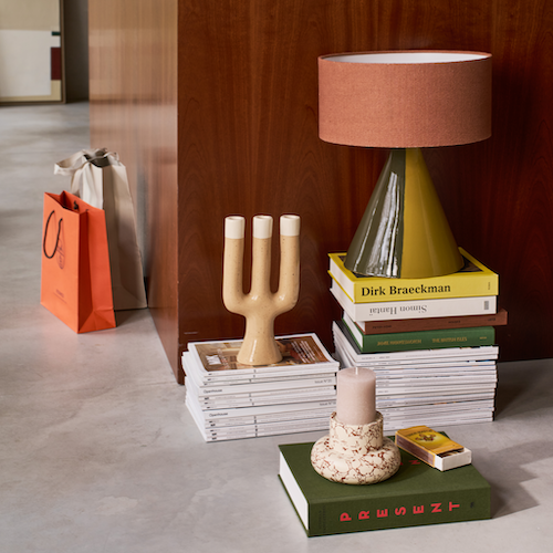 Nox three-arm natural ceramic candle holder by Urban Nature Culture styled with books and decor