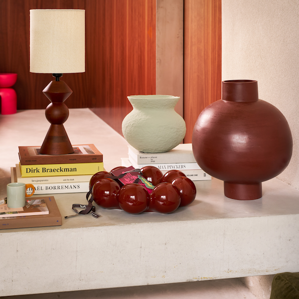 deep red sculptural earthenware pot ilo styled in a modern living room by urban nature culture
