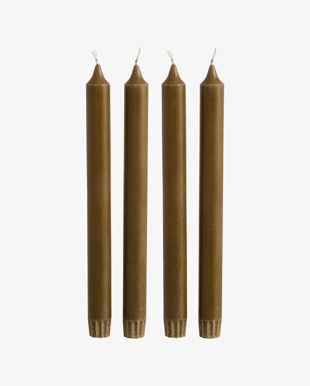 row of lit candles on a white mantelpiece shelf: two ceramic fish-shaped candlesticks holding olive green taper candles, a cluster of cream and dark olive green pillar candles of varying heights, and a brass candlestick holding an olive green taper candle, with framed artwork on the wall behind