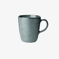 Speckled green stoneware mug adding warmth to slow morning routines