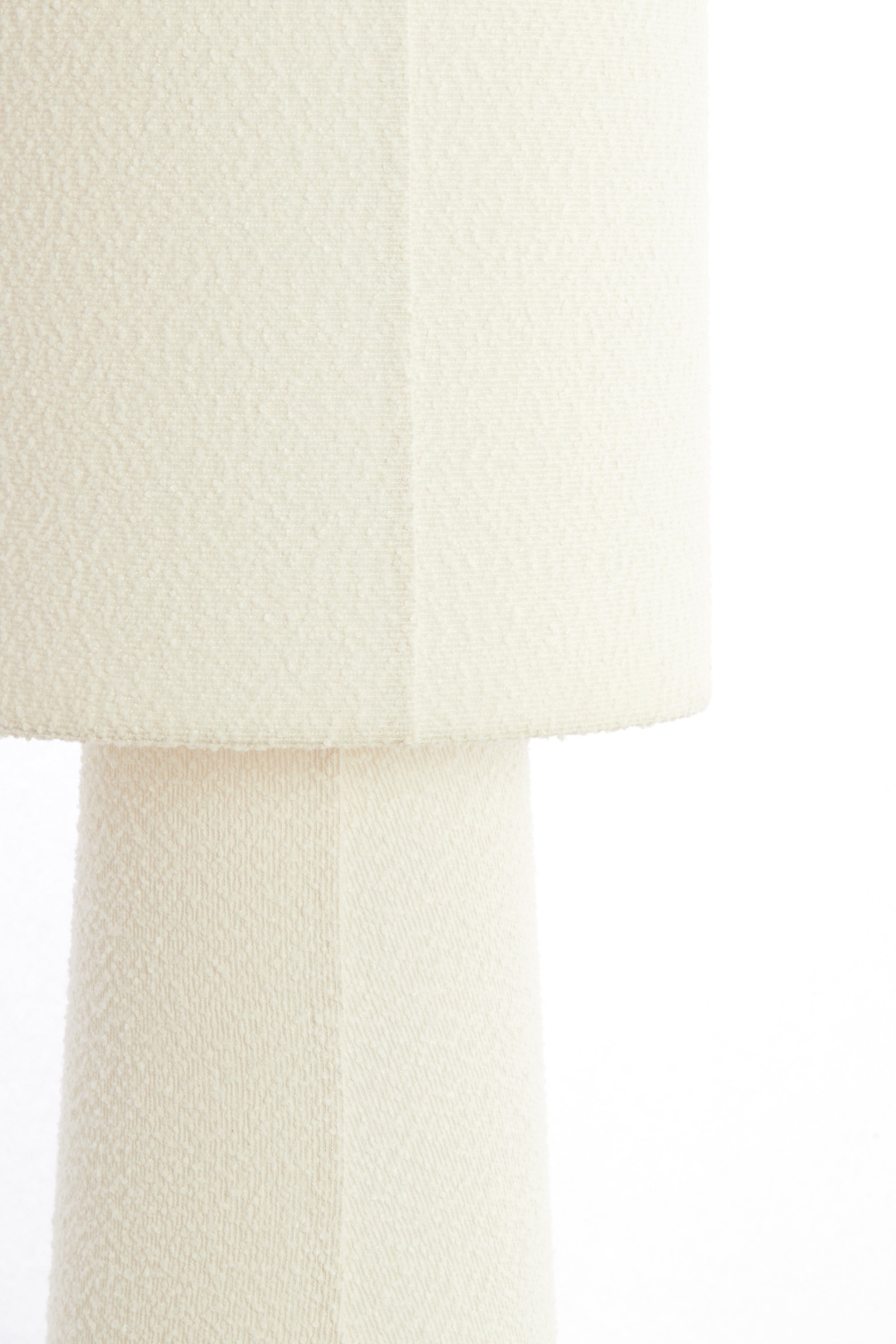 close-up of cream boucle fabric on floor lamp shade and base
