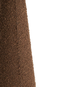 Lower base and cable detail of the DEVIA tall bouclé floor lamp in brown.
