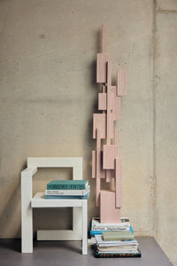 HKLIVING soft pink Skyscraper sculpture beside a white chair and stacked books