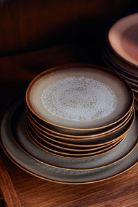 Stacks of HKLIVING Contrast plates in a wooden cabinet