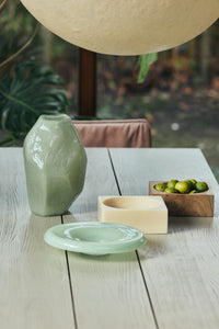 HKLIVING Pop Cube Large in Cream styled on a dining table with a ceramic vase, dish and bowl of limes