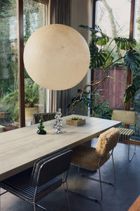 Lifestyle shot of the Forma Dining Table in Smoke by HKLIVING styled in a dining space