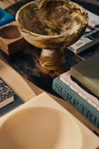HKLIVING Marbled Bowl on Base in Ochre displayed on a wooden table beside a stack of books
