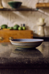 70s Ceramics curry bowl in Muted styled on a dark stone counter in a kitchen setting