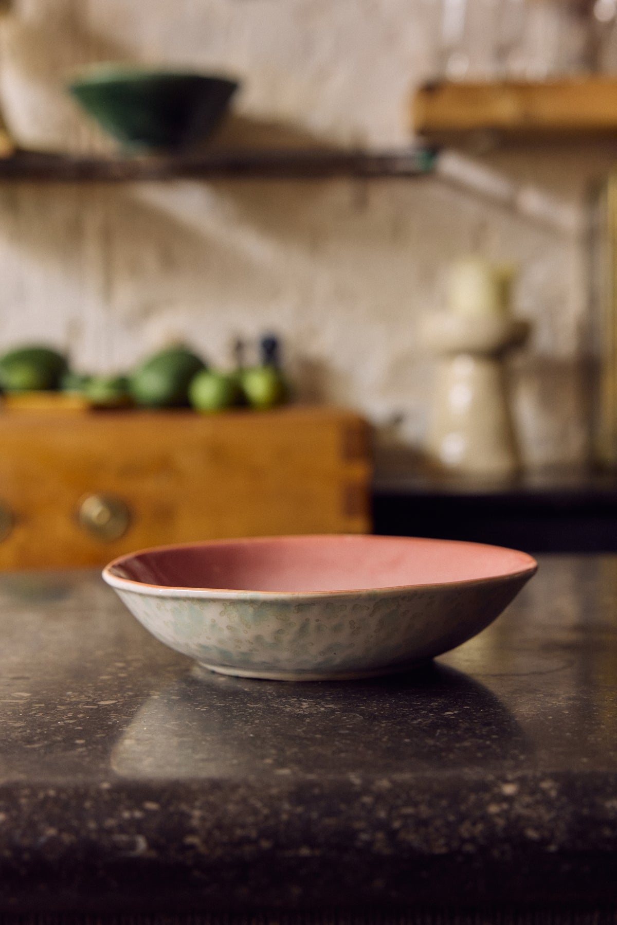 70s Ceramics curry bowl in Lotus styled on a dark stone counter in a kitchen setting