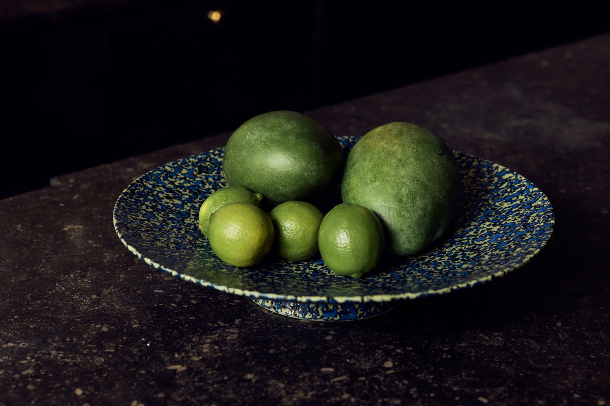 70s Ceramics Footed Fruit Bowl in Noise by HKLIVING styled on an open shelf beside other footed 70s ceramics bowls