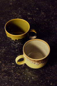 70s Ceramics tea mugs in Cravings styled on a dark stone counter, showing the glazed interiors