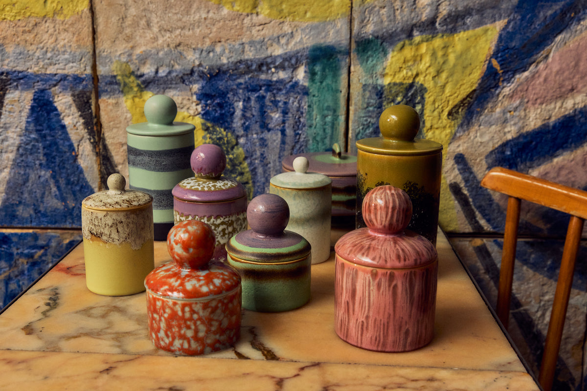 70s Ceramics storage jar in Custard displayed among a wider group of 70s ceramics storage jars in different colourways