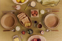 Breakfast table seen from above with bread, eggs, plates and HKLIVING lemon butter knives
