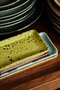 Close-up of HKLIVING 70s Ceramics yellow corn trinket dish stacked on plum and sage green dishes