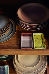 HKLIVING 70s ceramics Bloom XS dish styled in a wooden cabinet with colourful plates