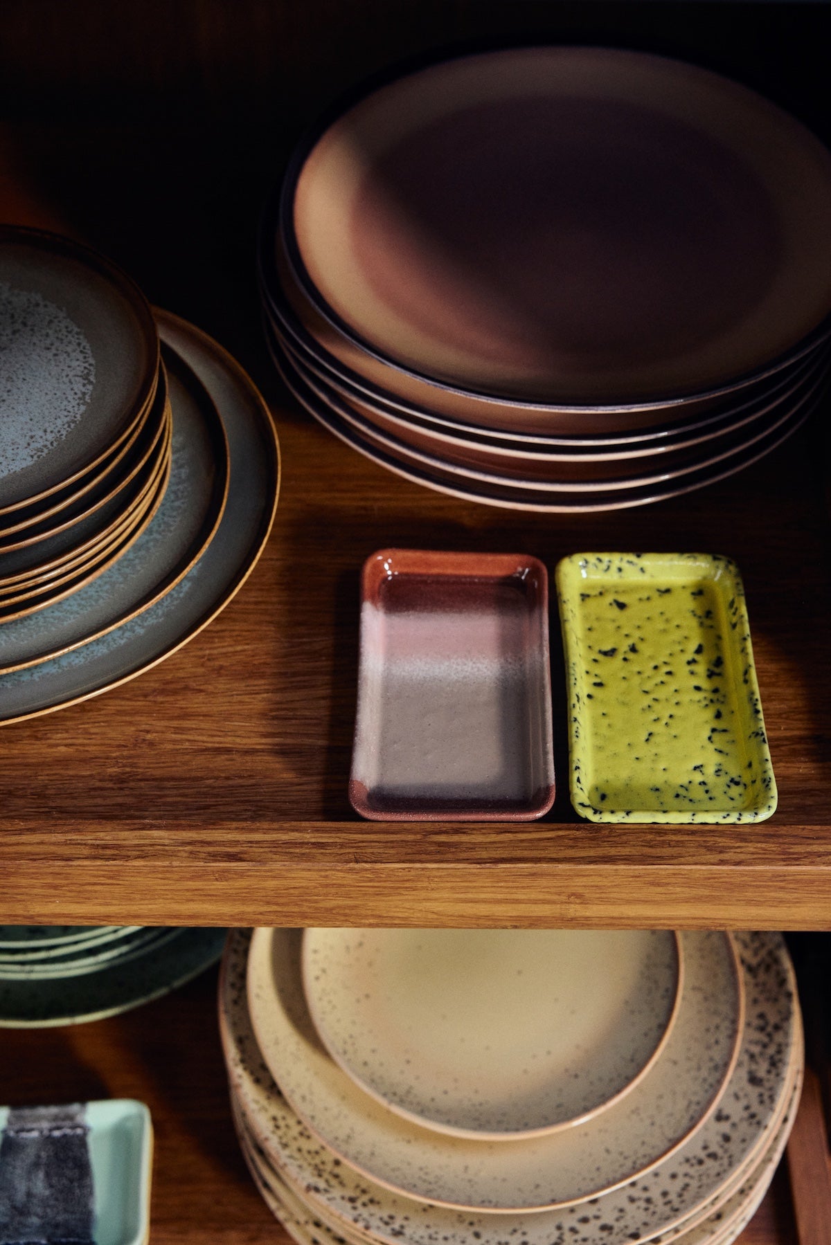 HKLIVING 70s ceramics Bloom XS dish styled in a wooden cabinet with colourful plates