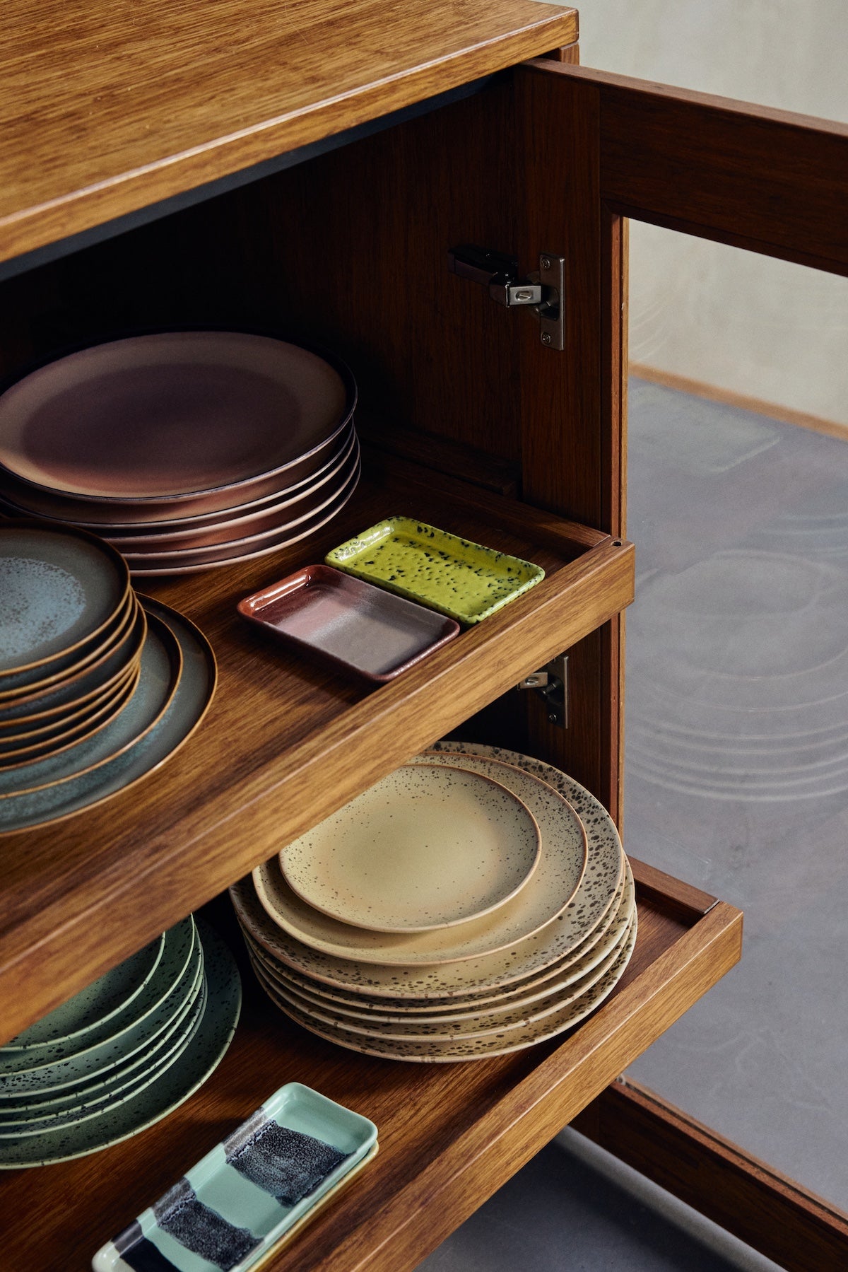 Bloom XS dish by HKLIVING styled beside yellow ceramic dish and stacked 70s tableware