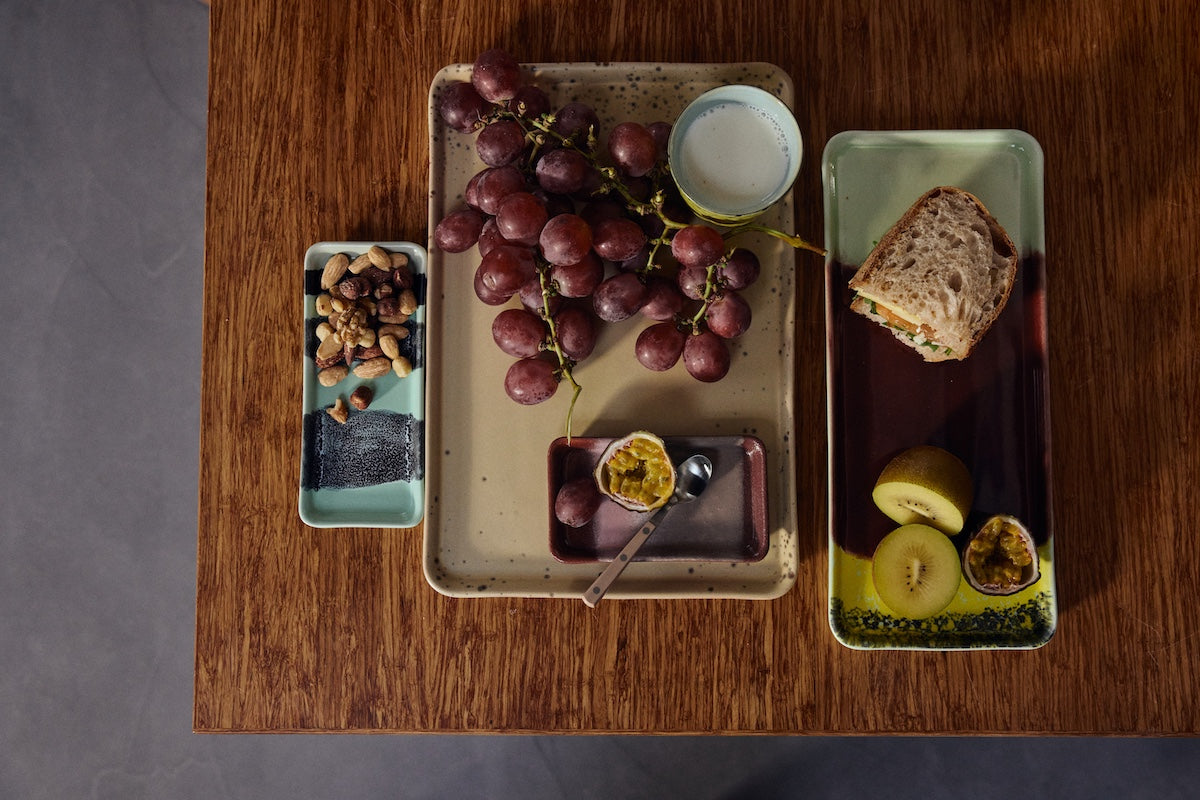 cherry stoneware cake tray by HKLIVING styled with fruit bread and colourful 70s ceramics