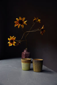 Van Gogh Sunflowers coffee mugs by HKLIVING styled beside yellow flowers in a vase