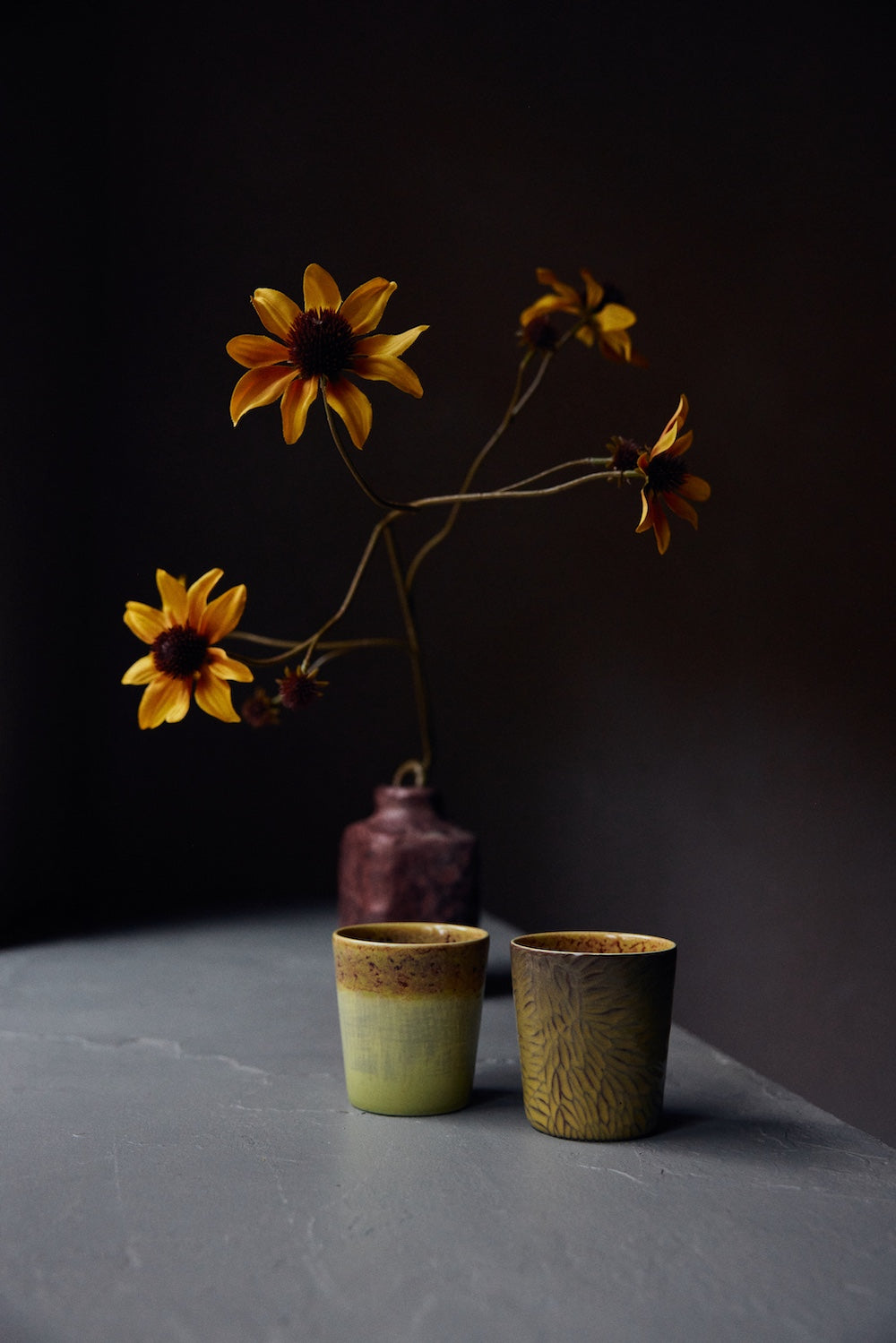 Van Gogh Sunflowers coffee mugs by HKLIVING styled beside yellow flowers in a vase