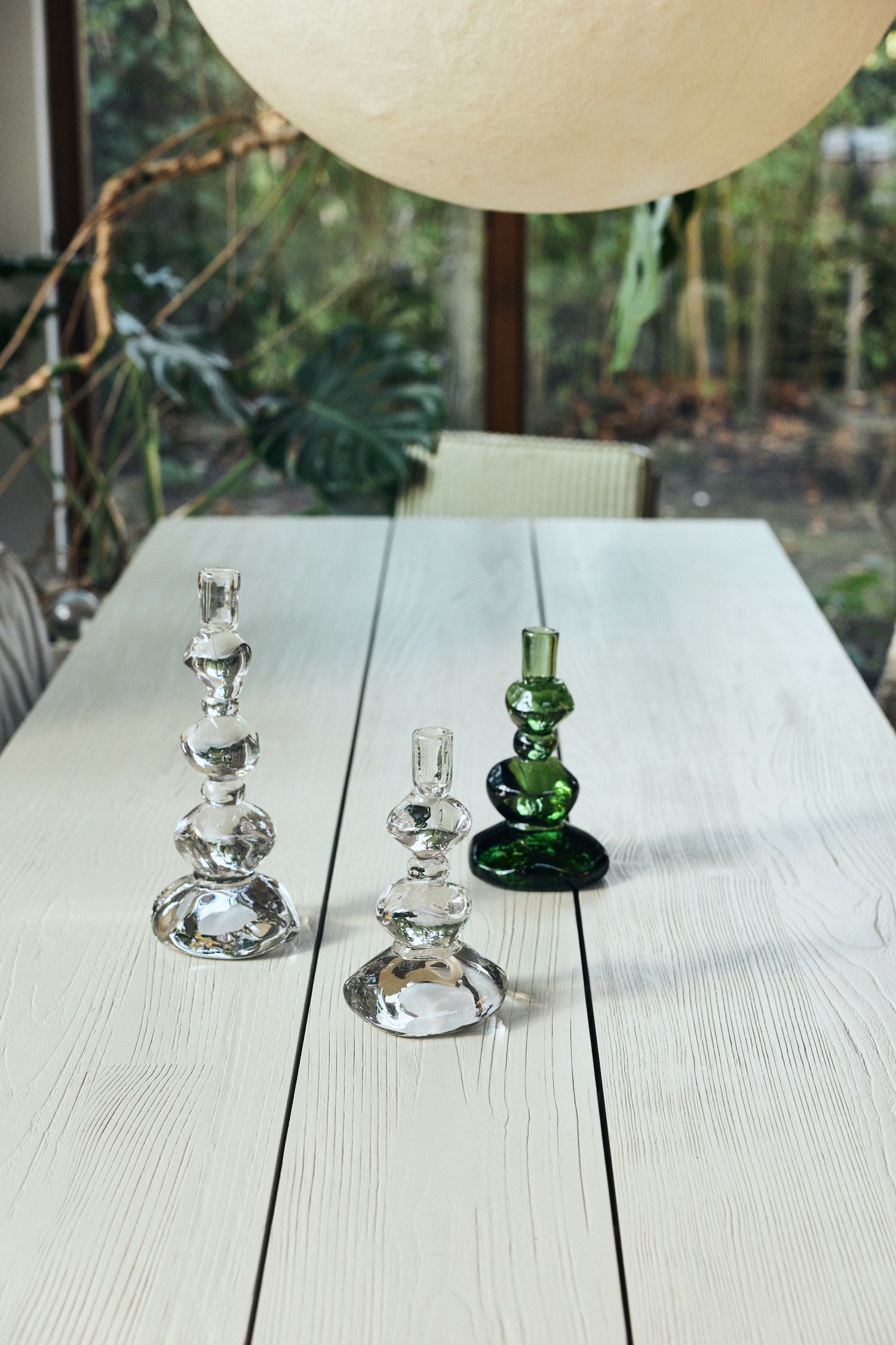 Emerald and clear glass candle holders from the Nienke Sikkema collection styled on a dining table