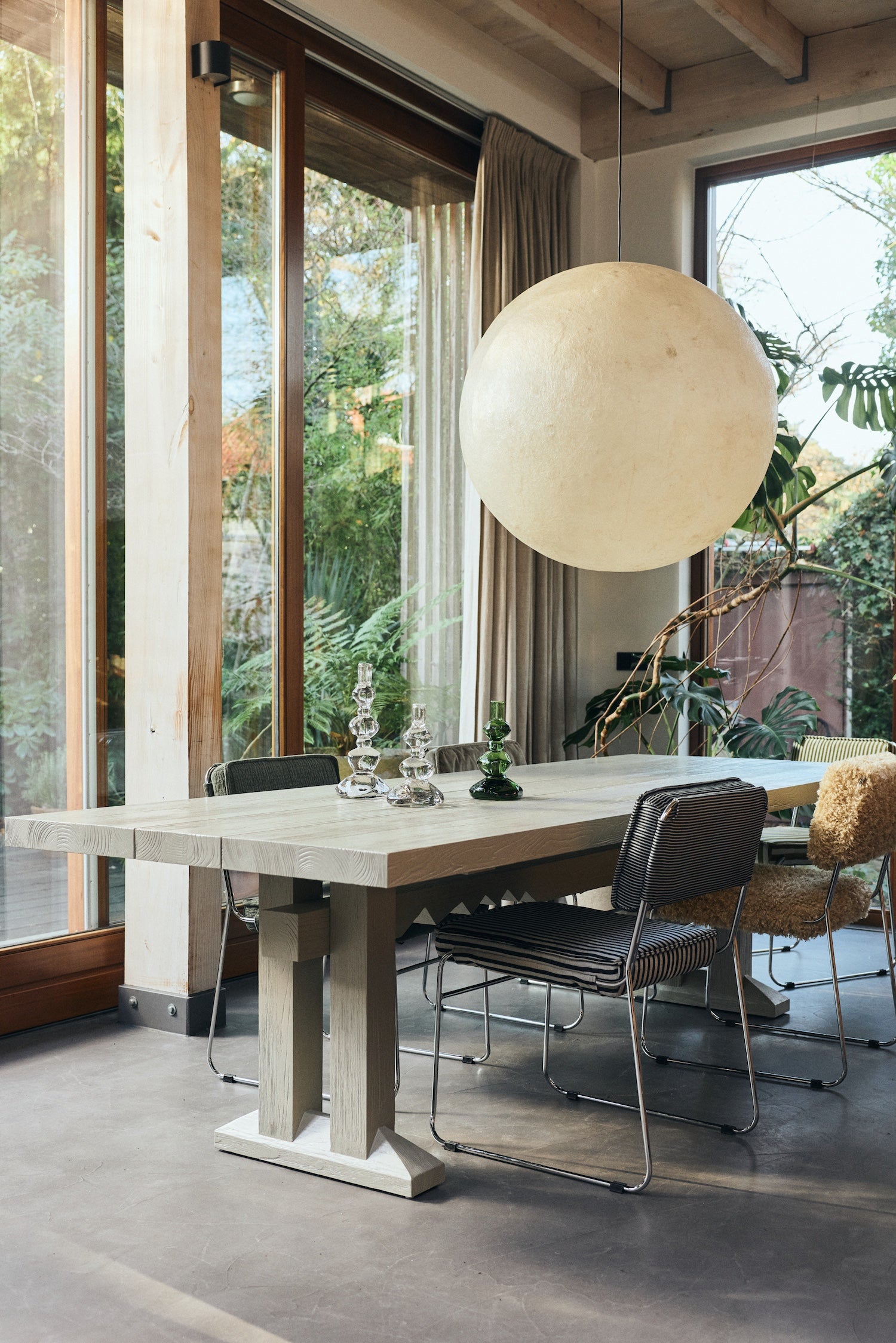 Nienke Sikkema glass candle holders styled in a Scandinavian dining room setting