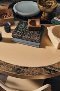 Small HKLIVING teak cube bowl on a stack of books, styled on a round table with bowls and trays
