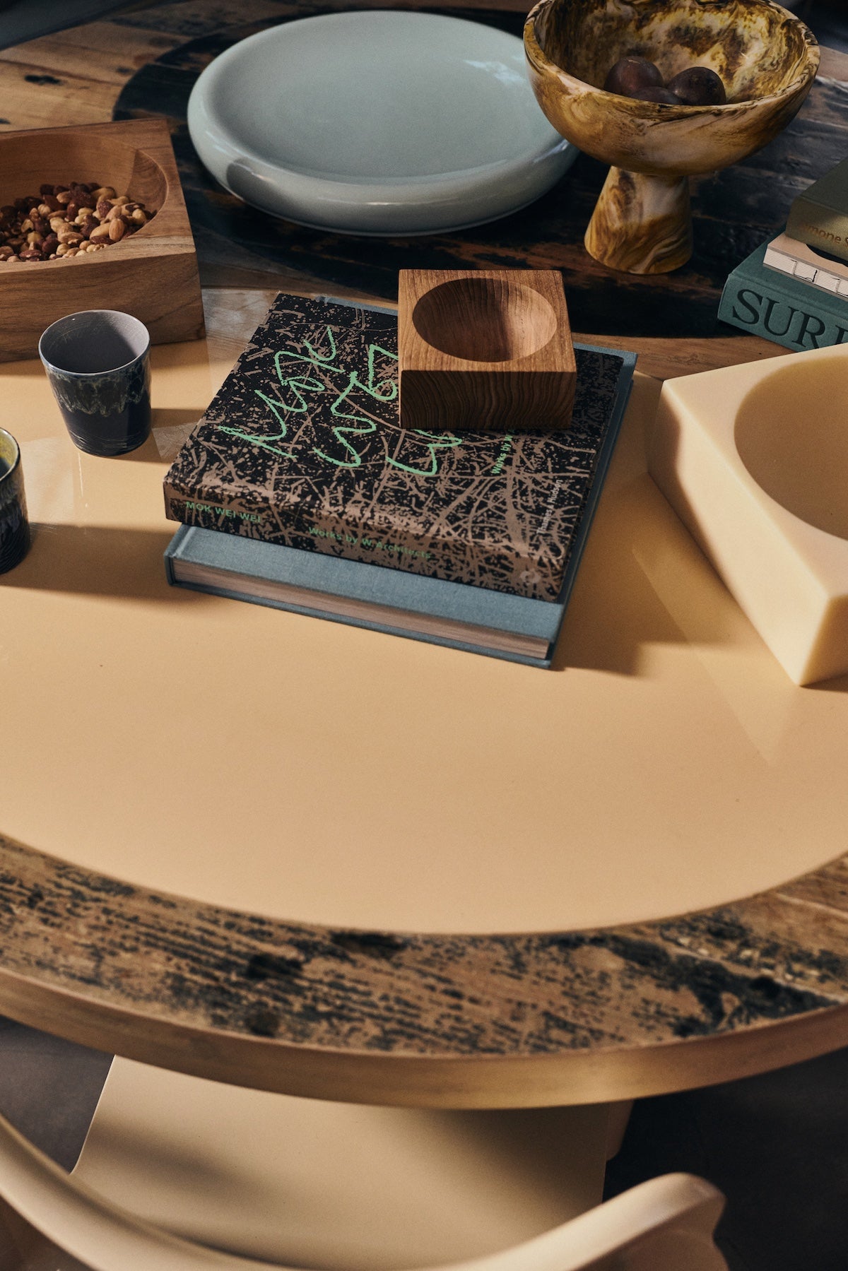 Small HKLIVING teak cube bowl on a stack of books, styled on a round table with bowls and trays