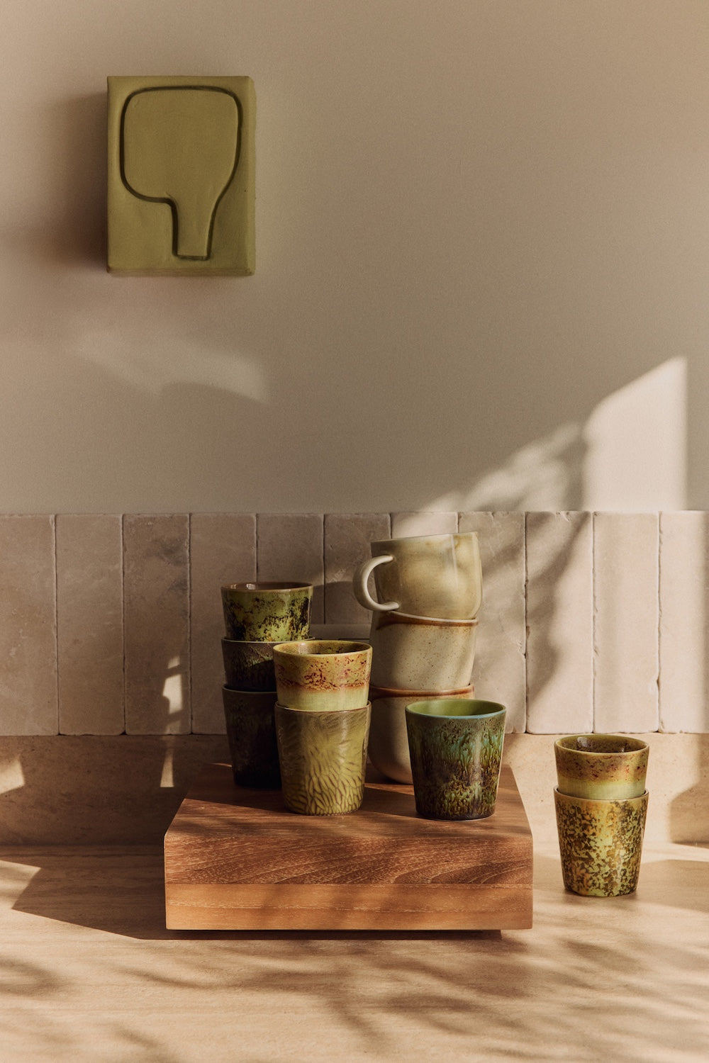 hkliving wall art in a kitchen above multicoloured coffee cups