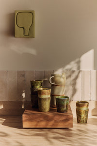 hkliving wall art in a kitchen above multicoloured coffee cups
