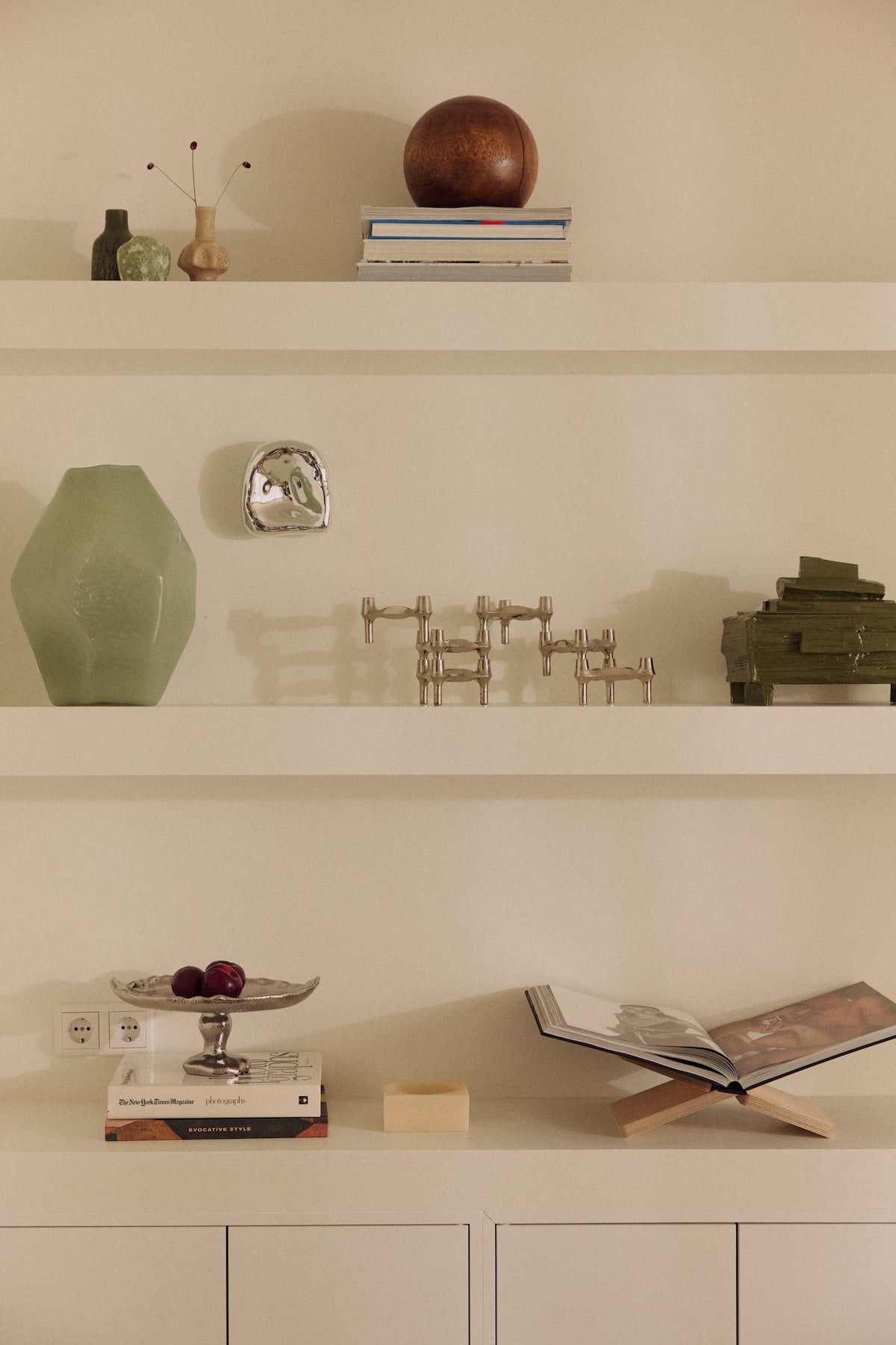 Nienke Sikkema for HKLIVING jade gemstone vase displayed on a shelf with small ceramic vases, candlesticks and books
