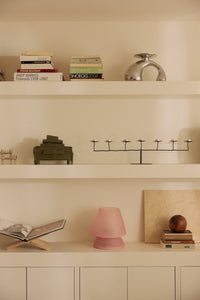 HKLIVING Glassfibre Table Lamp in Pink styled on a shelf alongside books and decorative objects
