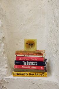 Soft Yellow Resin Table Clock by HKLIVING – styled on a stack of books