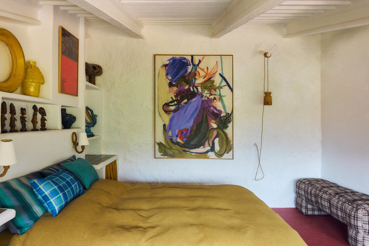 Abstraction framed artwork by HKLIVING styled above a bed with a mustard bedspread in a whitewashed, rustic bedroom