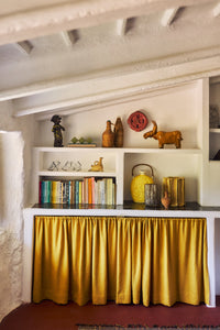 Terracotta Wall Clock by HKLIVING styled on an open shelf among ceramic figures and decorative objects