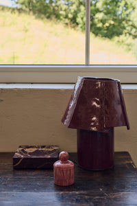 Burgundy cotton maché table lamp, campaign shot