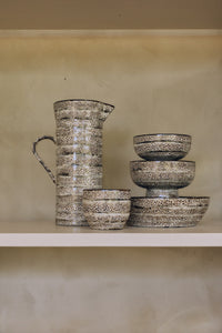 70s Ceramics tapas bowl on base in Brew styled on a shelf alongside a matching jug and cups from the same collection