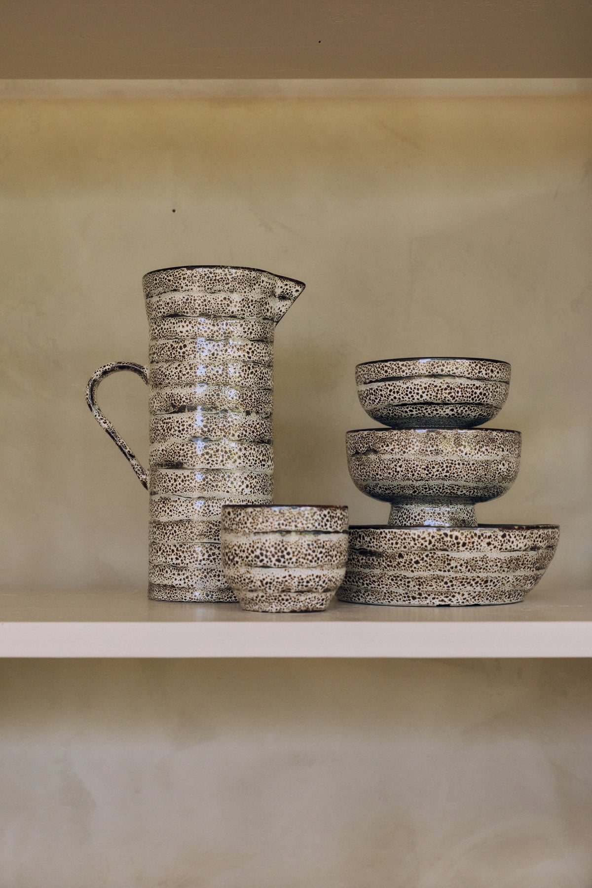 70s Ceramics tapas bowl on base in Brew styled on a shelf alongside a matching jug and cups from the same collection