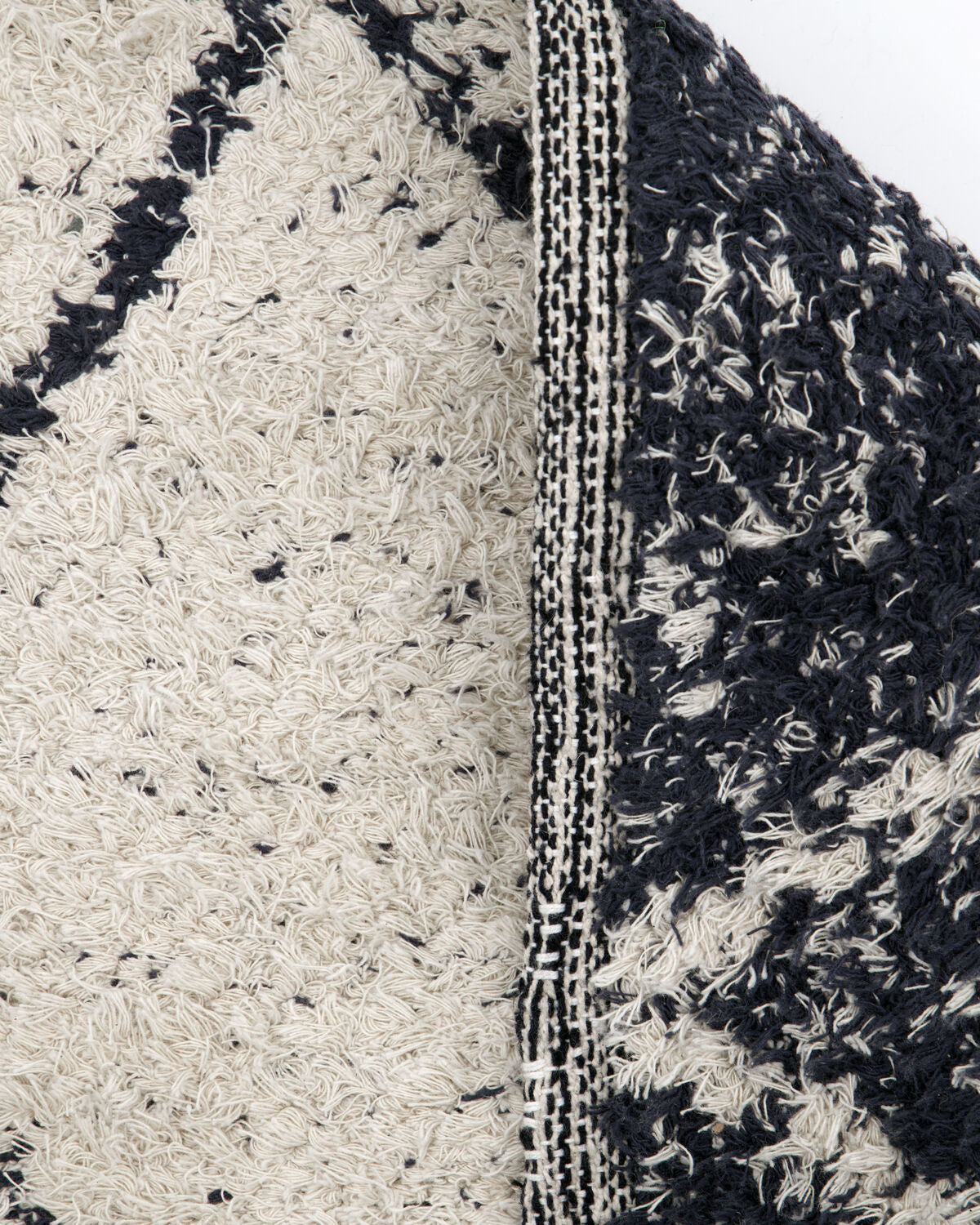 House Doctor Cruz rug close-up showing both sides and woven fringed edge