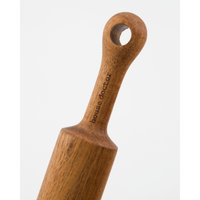 Detail of hanging hole and engraved logo on Eya rolling pin – warm wood finish

