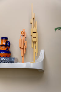 Lifestyle shot of the cream Retro Wall Shelf by HKLIVING styled in a showroom setting