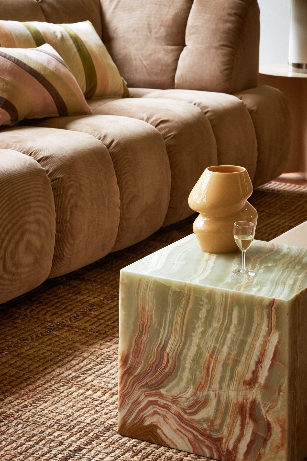 Green onyx HKLIVING marble block table beside a sofa, styled with a ceramic vase