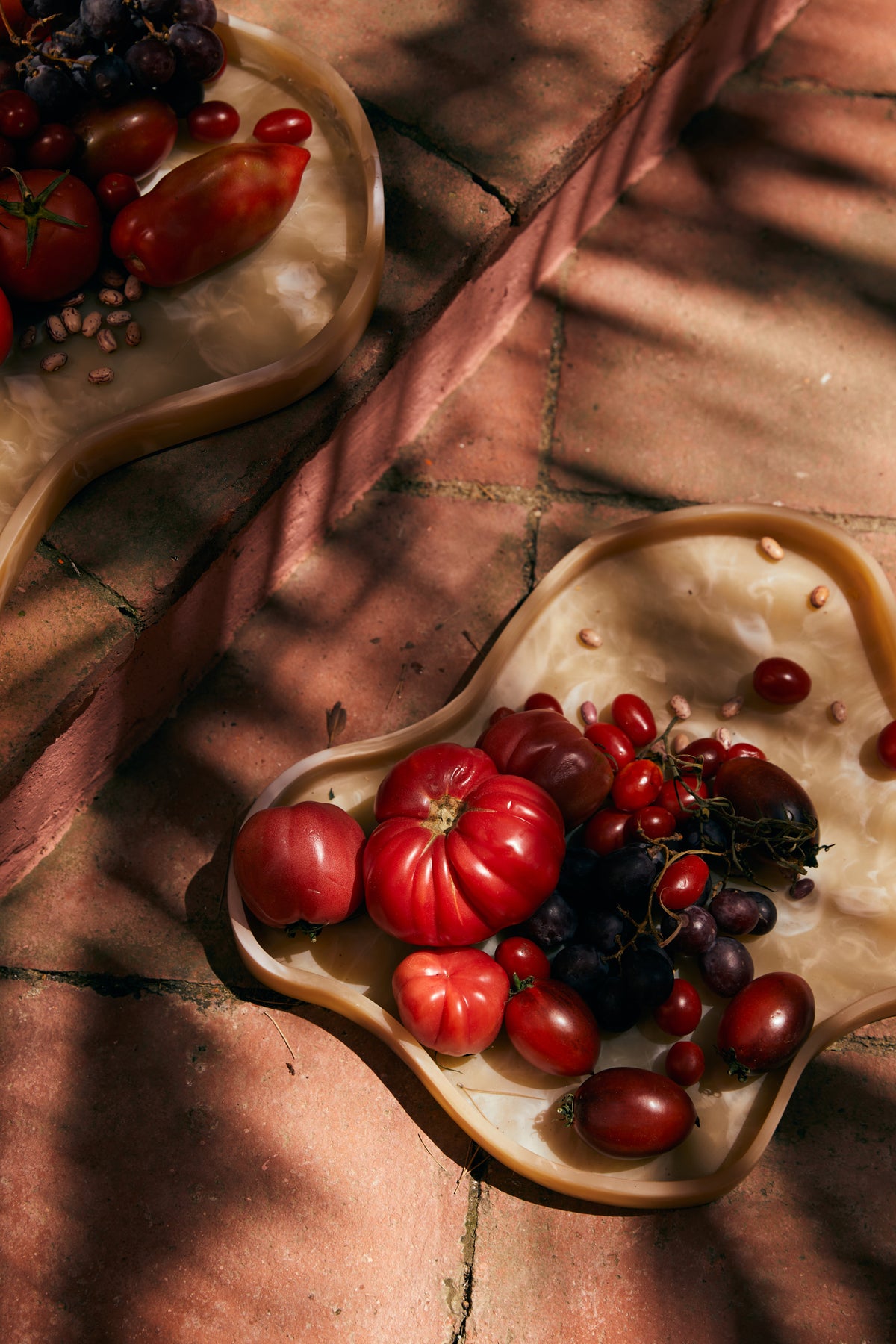 HKLIVING Patio tray with red fruit and berries on a terracotta tiled floor in dappled light