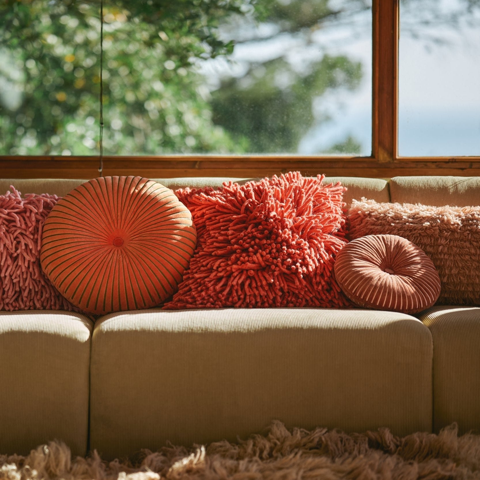Cherry red shaggy cushion 50x50cm by HKLIVING, styled on a sofa in a neutral living room
