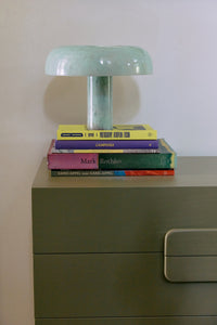 HKLIVING mint mushroom table lamp styled on a stack of art books on an olive green chest of drawers